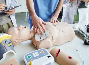 CPR supplies kit with manikins, AED trainer, gloves, etc
