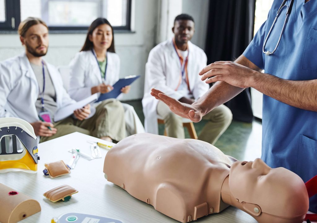 instructor teaching class on CPR dummy