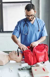 CPR instructor packing CPR items into bag